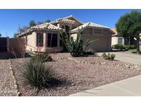 Charming single-story home featuring desert landscaping and a tile roof at 9853 W Pontiac Dr, Peoria, AZ 85382