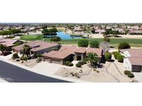 Stunning home with lush landscaping, tile roof, desert landscaping, and golf course views at 17406 N Escalante Ln, Surprise, AZ 85374