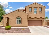Charming two-story home featuring a low maintenance yard and an attached two-car garage at 1876 E Azalea Ct, Gilbert, AZ 85298