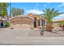 Charming single-story home with stucco facade, tile roof, desert landscaping, and attached two-car garage at 1882 W Wildhorse Dr, Chandler, AZ 85286
