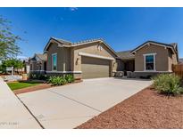Charming single-story home showcasing a wide driveway and a two-car garage at 21031 E Poco Calle St, Queen Creek, AZ 85142