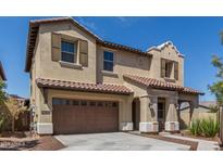 Inviting two-story home featuring a tile roof, attached two-car garage, and covered entryway at 2365 N Springfield St, Buckeye, AZ 85396