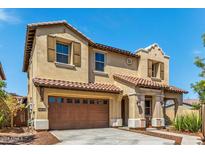 Stunning two-story home with a tile roof, charming shutters, and a convenient two-car garage at 2365 N Springfield St, Buckeye, AZ 85396
