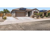 Charming single-story home featuring a two-car garage, solar panels, and low maintenance desert landscaping at 23730 W Hess Ave, Buckeye, AZ 85326