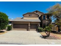 Two-story home featuring a two-car garage, mature landscaping, and a covered porch at 3502 W Belle Ave, San Tan Valley, AZ 85144