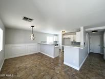 Open concept living room and kitchen area features updated finishes at 37061 W Bello Ln, Maricopa, AZ 85138