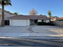Charming single-story home features desert landscaping, a two-car garage, and a red tile roof at 4332 E Frye Rd, Phoenix, AZ 85048