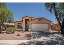 Charming single-story home featuring a two-car garage and neutral-toned exterior with desert landscaping at 4605 W Beverly Rd, Laveen, AZ 85339