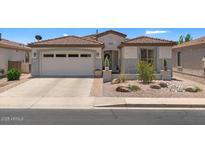 Charming single-story home with a well-maintained yard and a two-car garage at 4649 E Sourwood Dr, Gilbert, AZ 85298