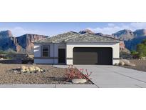 Charming single-story home features neutral stucco, grey roof, two-car garage and desert landscaping at 5457 E Mearn Rd, San Tan Valley, AZ 85140