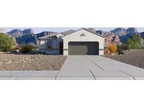 Charming single-story home showcasing desert landscaping and a spacious two-car garage at 5575 E Mearn Rd, San Tan Valley, AZ 85140