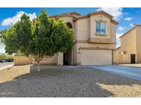 Charming two-story home featuring a two-car garage and a well-maintained gravel front yard at 894 S Buena Vista Dr, Apache Junction, AZ 85120