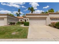 Alluring single-story house with a green lawn, attractive landscape, and spacious two-car garage at 9120 W Wescott Dr, Peoria, AZ 85382