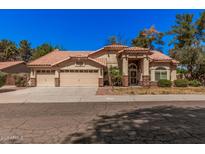 Charming single-story home showcasing a tile roof and a spacious three-car garage at 9414 S La Rosa Dr, Tempe, AZ 85284