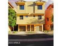 Inviting two-story townhome with tan stucco, dual front doors, and attached garages at 9551 E Redfield Rd # 1061, Scottsdale, AZ 85260