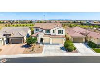 Aerial view of a two-story home with three-car garage, tile roof, and mountain views at 9677 W Patrick Ln, Peoria, AZ 85383