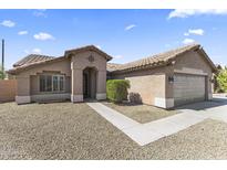 Charming single-story home with desert landscaping, tile roof, and inviting entrance at 10747 W Via Del Sol --, Peoria, AZ 85373