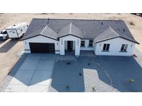 Aerial view of new construction featuring a neutral colored stucco, gray roof, and modern garage door at 11798 S 216Th Ave, Buckeye, AZ 85326