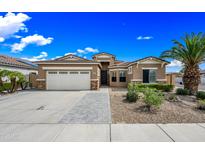Charming single-story home with a well-manicured front yard and a two-car garage at 16763 W Magnolia St, Goodyear, AZ 85338