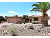 Charming single-story home with a tile roof, desert landscaping, and a spacious two-car garage at 17630 N Somerset Dr, Surprise, AZ 85374