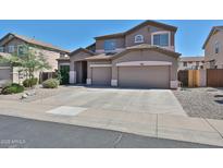 Charming two-story home features a spacious three-car garage and well-maintained landscaping at 18047 W Caribbean Ln, Surprise, AZ 85388