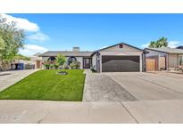 Charming single-story home featuring well-kept landscaping and a two-car garage at 1914 W Onza Ave, Mesa, AZ 85202