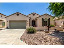 Charming single-story home featuring a well-manicured desert landscape and an attached two-car garage at 21059 E Pickett St, Queen Creek, AZ 85142