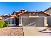 Charming single-story home with a well-manicured front yard and a spacious two-car garage at 2223 E Crest Ln, Phoenix, AZ 85024
