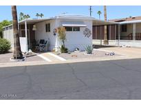 Well-maintained manufactured home with desert landscaping and covered parking at 303 S Recker Rd # 247, Mesa, AZ 85206