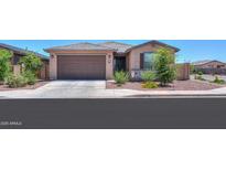 Charming single-story home featuring a two-car garage and desert landscaping at 35175 W Marin Ave, Maricopa, AZ 85138