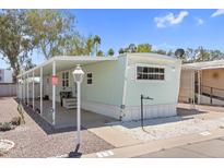 Charming single-story home featuring a covered porch and well-maintained gravel landscaping at 535 S Alma School Rd # 17, Mesa, AZ 85210