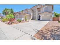 Spacious stucco two-story home with a large driveway and two-car garage at 6027 N 132Nd Dr, Litchfield Park, AZ 85340