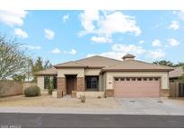 Inviting single-story home with desert landscaping and a two-car garage at 6103 S 54Th Ave, Laveen, AZ 85339