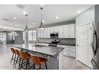 Modern kitchen features sleek countertops, stainless steel appliances, and a stylish backsplash at 7824 S 33Rd Ln, Laveen, AZ 85339