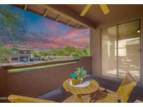 Private balcony features peaceful desert views, cozy seating, and a beautiful sunset at 11500 E Cochise Dr # 2088, Scottsdale, AZ 85259
