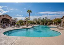 Enjoy resort-style living with this community pool, surrounded by palm trees and lounge chairs at 11500 E Cochise Dr # 2088, Scottsdale, AZ 85259