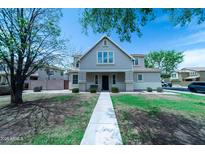Charming two-story home featuring landscaped yard, covered porch, and inviting walkway at 12161 W Flanagan St, Avondale, AZ 85323