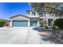 Charming two-story home featuring a three-car garage and drought-tolerant landscaping at 14430 W Windsor Ave, Goodyear, AZ 85395