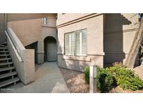 Inviting condo exterior with private entrance, covered stairs, and desert landscaping at 15252 N 100Th St # 1134, Scottsdale, AZ 85260