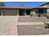 Inviting single-story home with a low-maintenance desert landscape and covered entry at 15352 W Ventura St, Surprise, AZ 85379