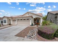 Inviting single-story home with desert landscaping, covered porch, and three-car garage at 16636 S 22Nd St, Phoenix, AZ 85048
