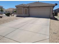 Well maintained single-story home featuring desert landscaping and a spacious driveway at 1769 E Jacob St, San Tan Valley, AZ 85140