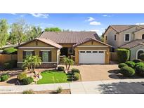 Charming single-Gathering home showcasing a well-manicured lawn, beautiful shrubbery, and a two-car garage at 19291 E Thornton Rd, Queen Creek, AZ 85142