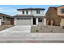 Two-story home boasts a minimalist landscaped front yard and attached two-car garage at 24232 W Agora Ln, Buckeye, AZ 85326