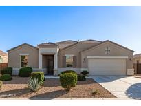 Beautiful single-story home featuring a two-car garage and well-manicured desert landscaping at 30089 W Rockmount Ave, Buckeye, AZ 85396