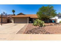 Charming one-story home featuring desert landscaping, a two-car garage and a basketball hoop at 4316 E Janice Way, Phoenix, AZ 85032