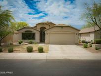 Charming single-story home featuring a well-manicured front yard, a two-car garage, and a beautiful roof at 4609 E Adobe Dr, Phoenix, AZ 85050