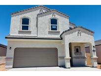 Two-story home features a neutral color scheme, arched windows, and a convenient attached two-car garage at 5058 E Umber Rd, San Tan Valley, AZ 85143