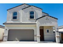 Charming two-story home featuring a stucco exterior, a gray tile roof, and an attached two-car garage at 5058 E Umber Rd, San Tan Valley, AZ 85143