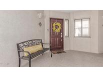Inviting front door with a cheerful wreath and bench, creating a warm and welcoming entrance at 5104 N 32Nd St # 144, Phoenix, AZ 85018